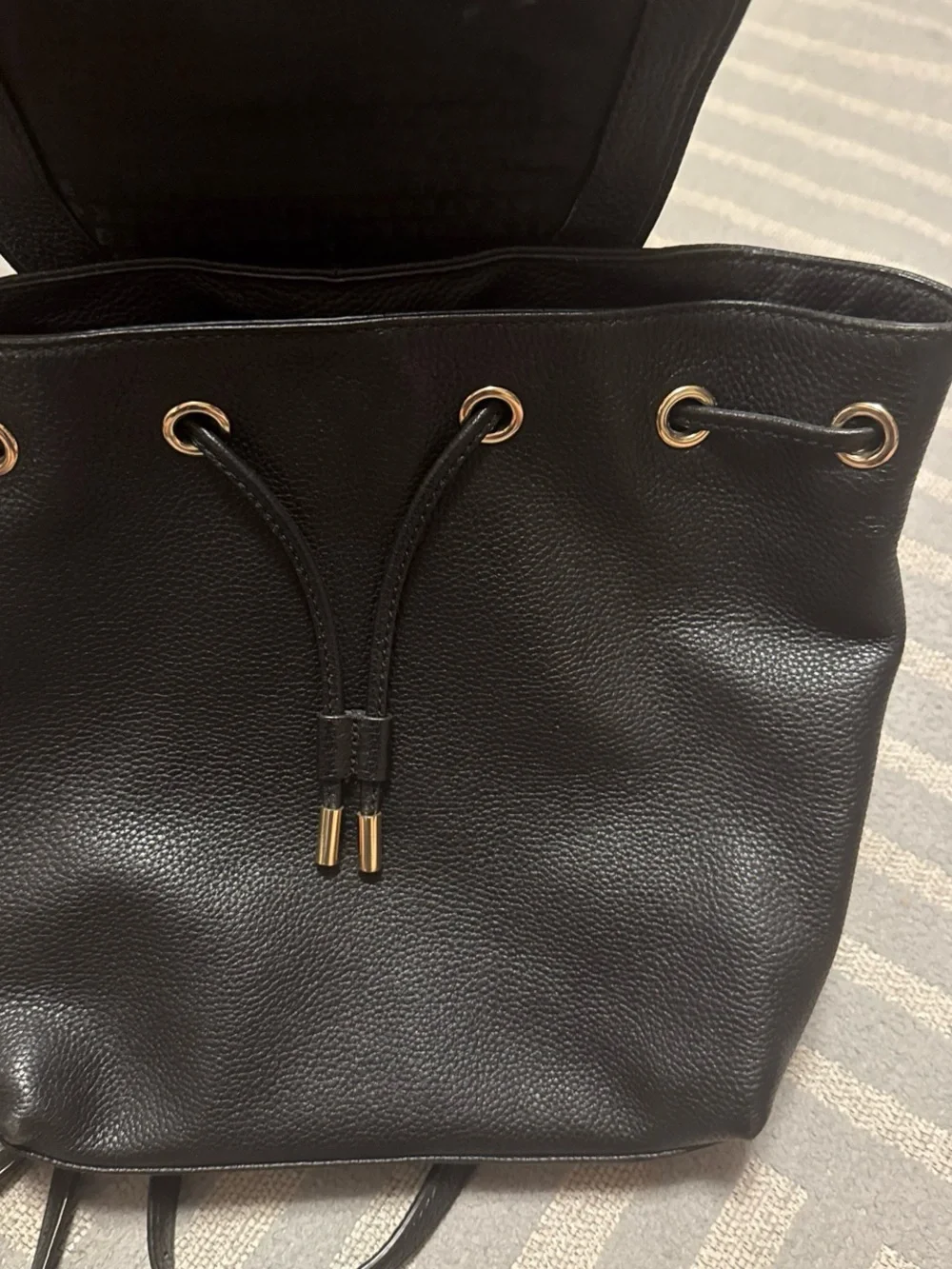 kate spade black pebbled leather flap drawstring backpack